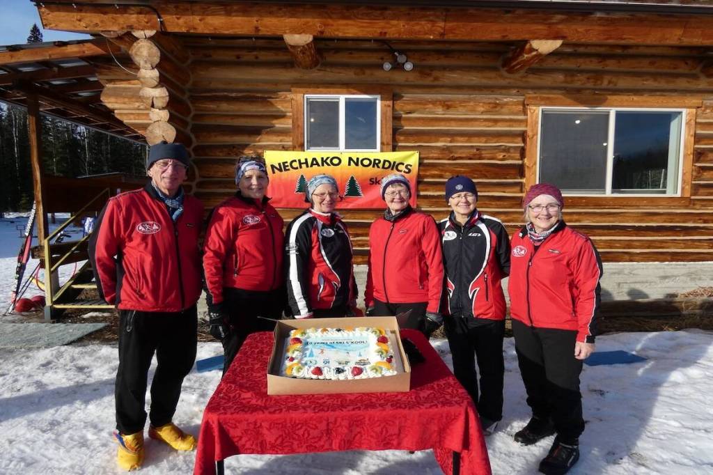 Volunteer coaches Richard Burkholder, Val Erickson, Pat Swenson, Renate Price, Norma Neufeld and Mary Burkholder pose with cake at 10th anniversary of the ski s&rsquo;kool. (Facebook)